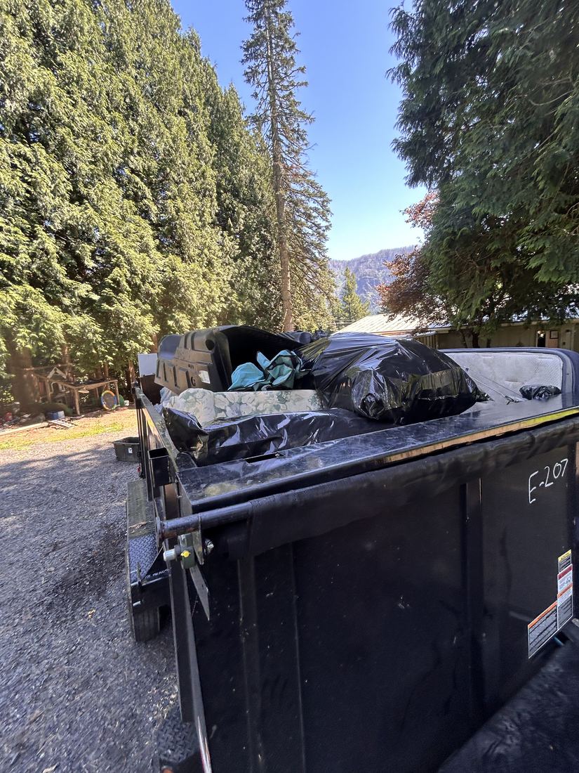 Dump trailer loaded with furniture and junk
