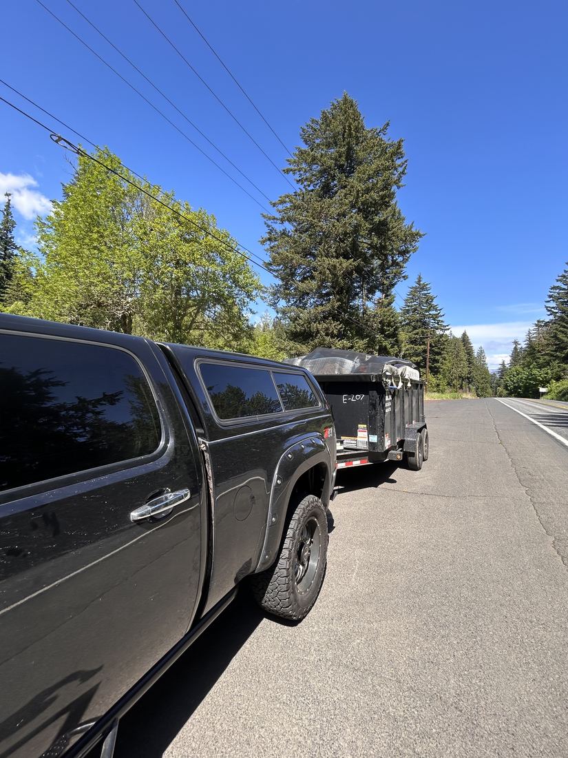 JunkBrozz truck hauling a covered load