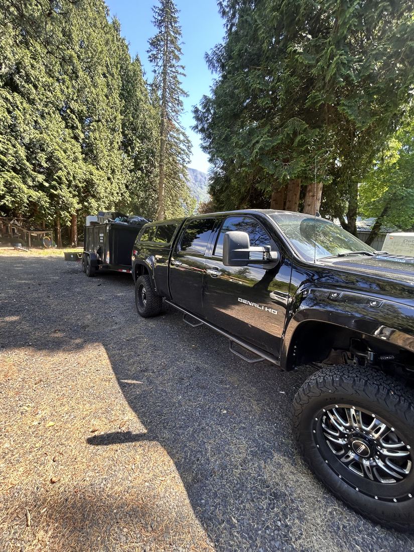 JunkBrozz truck with a loaded dump trailer on site