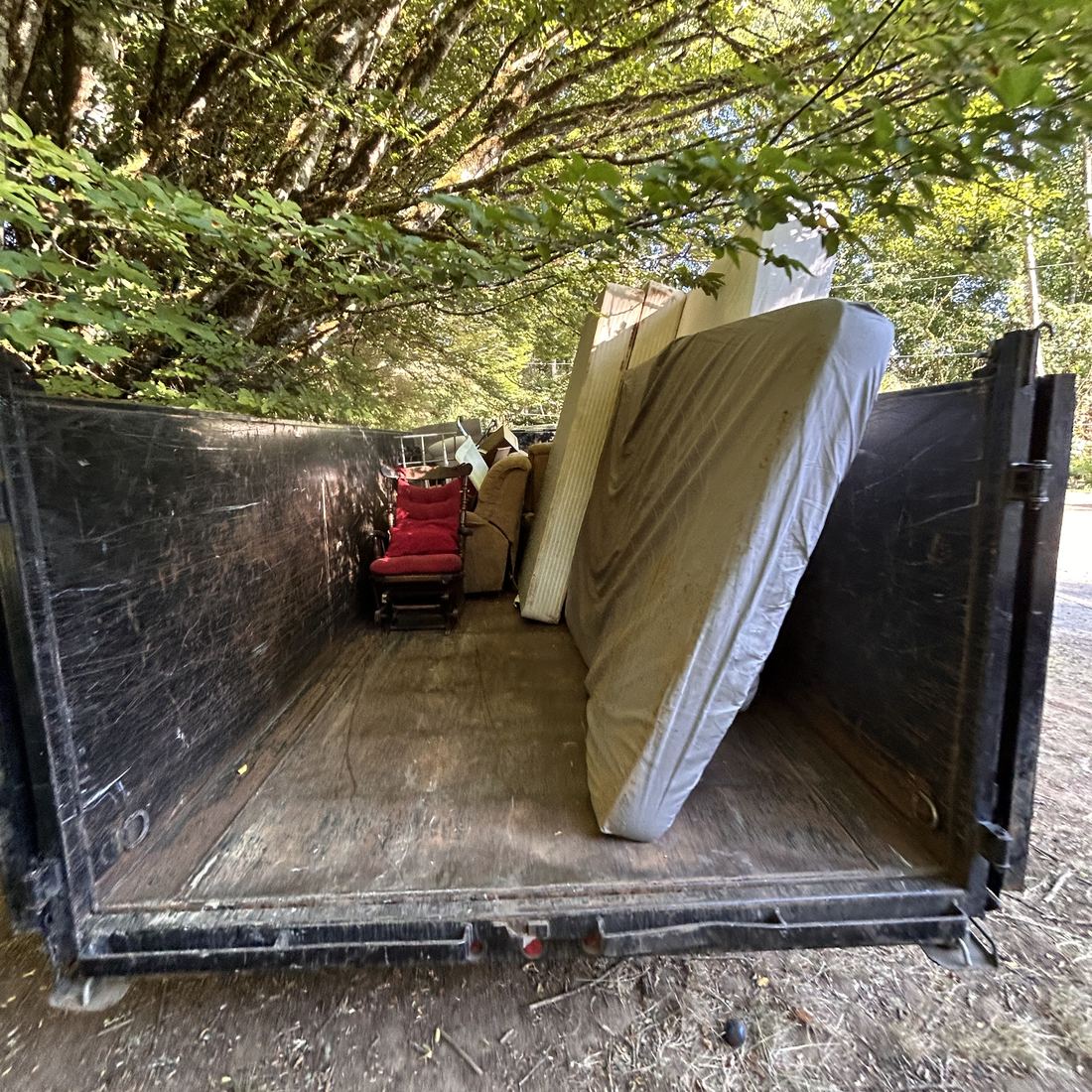 Trailer loaded with a mattress and couch